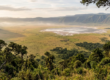 Aerial-style view of the Ngorongoro Crater floor with a lake and grazing herds